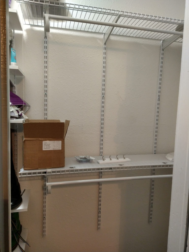 Image showing the interior of my new closet, with two closet rods mounted to the back wall.